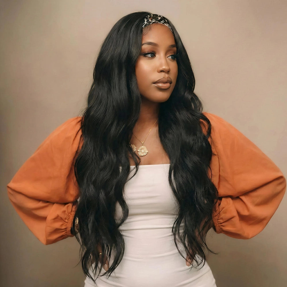 Mimicing Body Wave headband glueless virgin hair wig styled with a leopard print headband, featuring a woman in an orange and white outfit posing with hands on hips against a neutral studio background to highlight the long, voluminous wavy hair.
