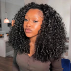 Mimicing Burmese curly glueless virgin hair half wig worn by a model in a kitchen setting, showcasing voluminous and natural defined curls.